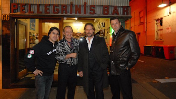 Nick Giannopoulos (left), Sisto Malaspina, Russell Crowe and another man pose for a photo at the front of Pellegrinis Bar in Melbourne.