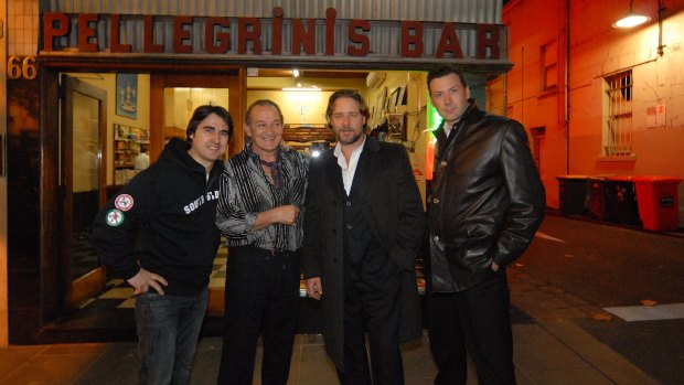 Nick Giannopoulos (left), Sisto Malaspina, Russell Crowe and another man pose for a photo at the front of Pellegrinis Bar in Melbourne.