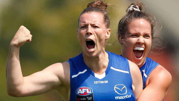 North Melbourne's Brittany Gibson (left) celebrates a goal against Carlton with Emma Kearney. 