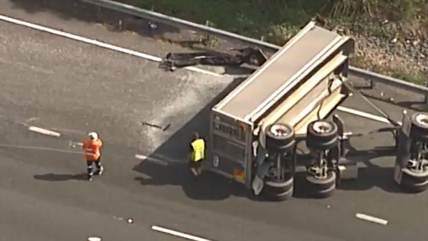 Southbound lanes of the M1 remain closed after the truck trailer rolled.