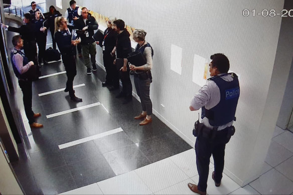 Victoria Police and Australian Border Force officers raid Frank Hu’s Melbourne office in 2019.