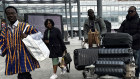 Travellers arrive at Heathrow as  the airport slowly resumes flights after a fire cut power and shut it down.