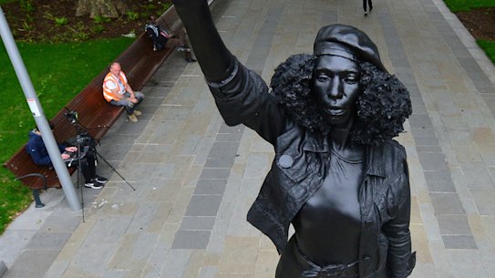 A new black resin and steel statue entitled "A Surge of Power (Jen Reid) 2020" by artist Marc Quinn stands after the statue was put up this morning on the empty plinth of the toppled statue of 17th century slave trader Edward Colston.