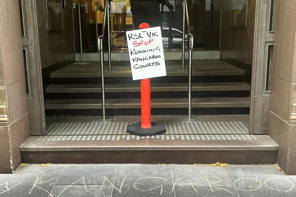 Protest signs outside the tribunal held for Lucas Moon at Anzac House in Melbourne.