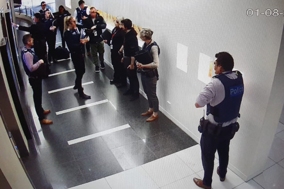 Victoria Police and Australian Border Force officers raid Frank Hu’s Melbourne office in 2019.
