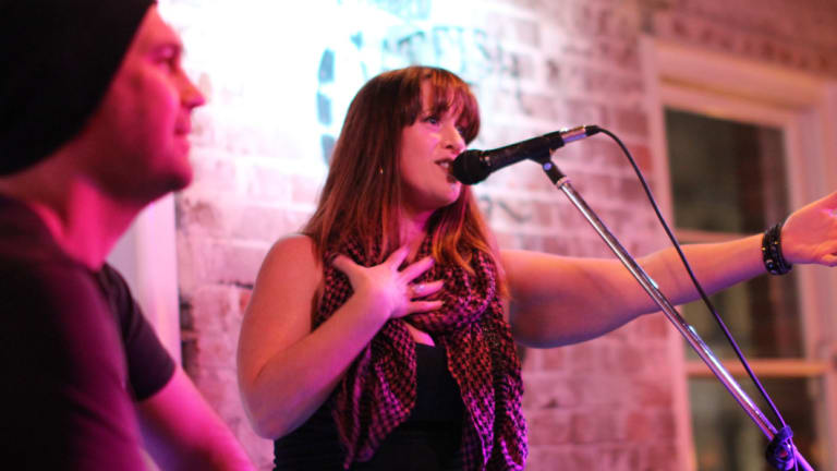 Bek Jensen, the musical director of the Welcome Choir, teaching a song at the Newtown event.