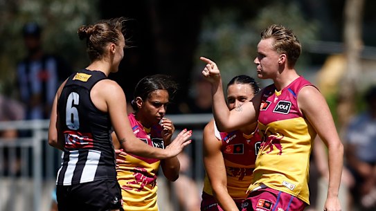 Jordyn Allen of the Magpies and Dakota Davidson of the Lions clash after the final siren.