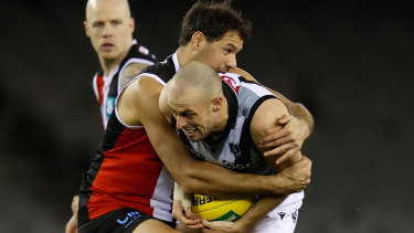 Jarrod Lienert is tackled by Paddy Ryder.