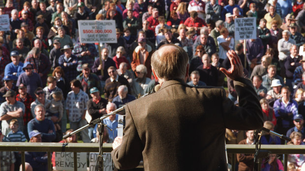 Then prime minister John Howard wears a bullet-proof vest at a rally in Sale in June 1996 to argue for gun restrictions in the wake of the Port Arthur massacre. 