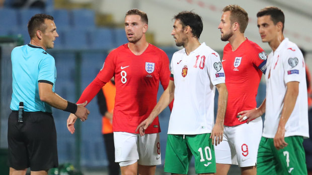 Referee Ivan Bebek speaks with Jordan Henderson and Harry Kane of England along with Ivelin Popov of Bulgaria during the controversial match in Sofia.