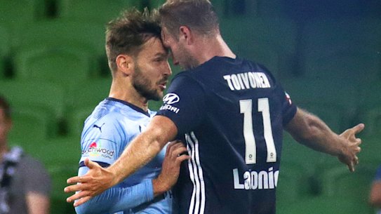 Victory's Ola Toivonen and Milos Ninkovic of Sydney FC clash.