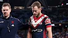 Sam Walker of the Roosters walks off injured.