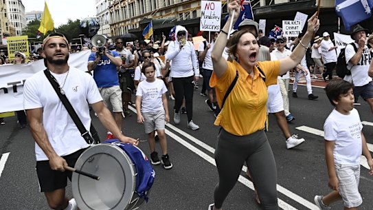 Children were among a large crowd protesting on Saturday against vaccine mandates and the cancellation of tennis player Novak Djokovic’s visa.