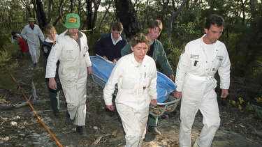 Rescue workers remove the body of a female British backpacker after it was discovered in the Belanglo State Forest on September 20, 1992. 