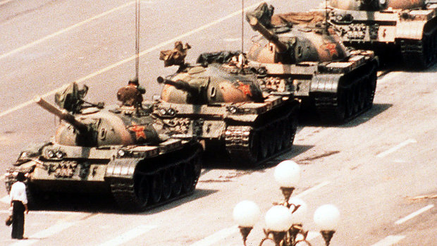 A lone protester clutching a shopping bag prevents a line of tanks from reaching Tiananmen Square on June 4, 1989.