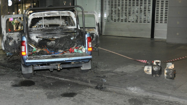 Crime scene photos show the gas bottles pulled from the burnt-out ute.
