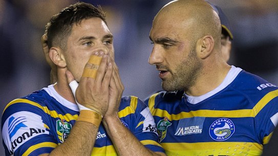 Mitchell Moses is consoled by Tim Mannah after a loss in 2018.