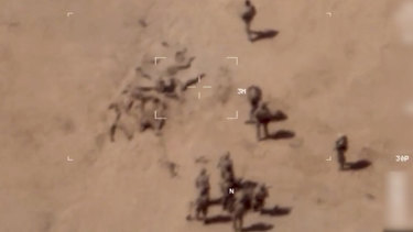 This image taken from a video shows soldiers burying bodies near an army base in northern Mali. 