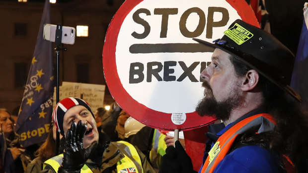 A pro-Brexit supporter, left, and a remain supporter near the Parliament in London.