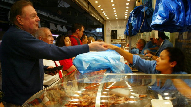 Christmas 2000’s: Christmas Eve shoppers make a last-minute dash to the Meat & Fish Hall of Queen Victoria Market with chilled seafood having the edge on the traditional hot roast for many Melburnians.
