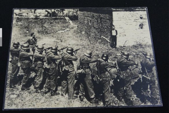 An image from the “Photo Album - Jewish Concentration Camp & Atrocity Photos” listing, showing a man facing a firing squad.