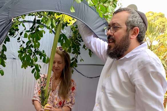 Nikki Goldstein and Rabbi Eli Schlanger at Goldstein's home to help him observe Sukkot, a Jewish festival that commemorates God's protection of the Israelites during their 40 years of wandering in the desert.