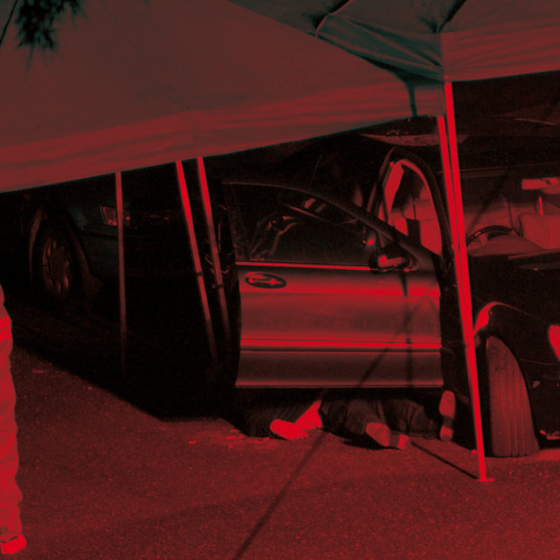 The scene of Michael McGurk’s execution, his body partly obscured, at the driveway of his home on Sydney’s lower north shore.