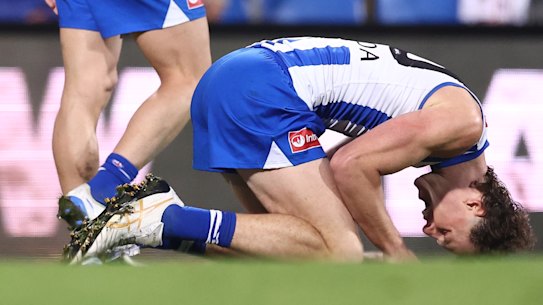 North Melbourne players accept the hollow feeling of a draw.,