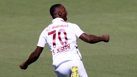  Shamar Joseph celebrates taking the prized wicket of Steve Smith in Adelaide.