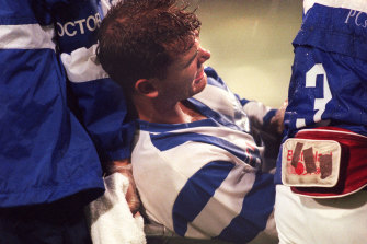 Wayne Carey in agony after dislocating his shoulder in 1997.