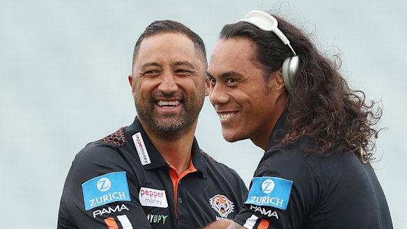 Jarome Luai shares a joke with Tigers coach Benji Marshall.