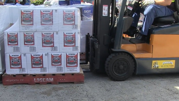 Alcohol is loaded onto a truck.