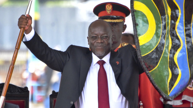 Tanzania's John Pombe Magufuli holds up a ceremonial spear and shield to signify the beginning of his presidency in 2015.