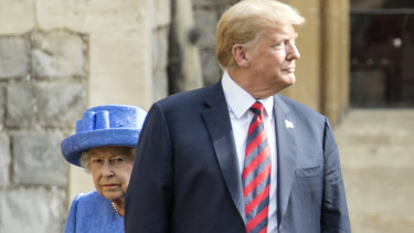 The Queen seems to be momentarily upstaged by Donald Trump in the Quadrangle while inspecting a Guard of Honour on Friday.
