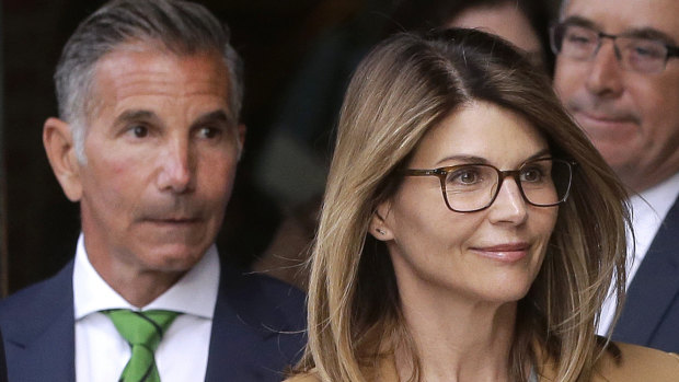 Lori Loughlin (right) and husband Mossimo Giannulli (left) depart a federal court on Tuesday.