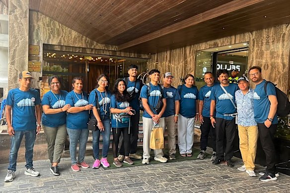 The Iyers appeared in a tour group photo. smiling and wearing matching shirts, a day before the floods hit.