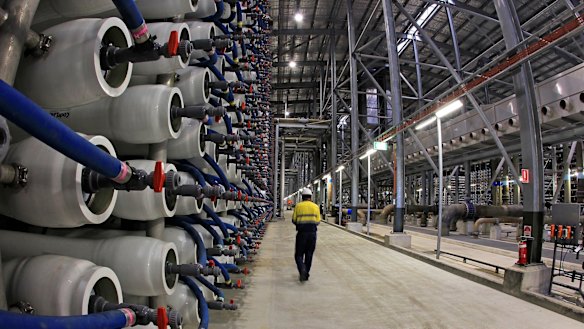 An employee of the Sydney Desalination plant walks past some of its 36,000 polymer membranes used to filter salt and other impurities from seawater so that it can suitable for drinking.