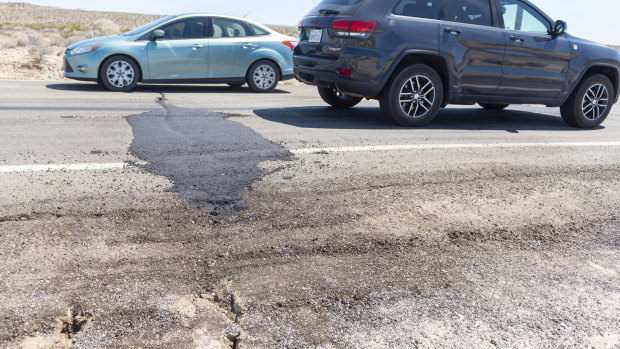 Traffic drives over a patched section of Highway 178 between Ridgecrest and Trona, California on Friday.