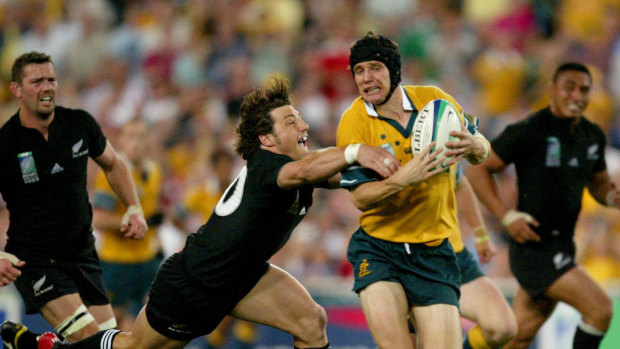 Stephen Larkham with the ball in Australia's semi-final against New Zealand in 2003. 