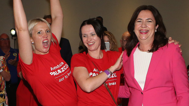 Premier Annastacia Palaszczuk, right, celebrates her election win with her sisters Julia and Nadia. 