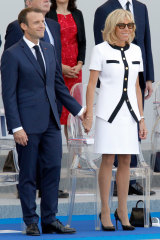 President Emmanuel Macron and his wife Brigitte Macron attend the traditional Bastille Day military parade in 2018.