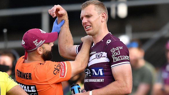 Tom Trbojevic grimaces while having his shoulder assessed after injuring it against the Titans.