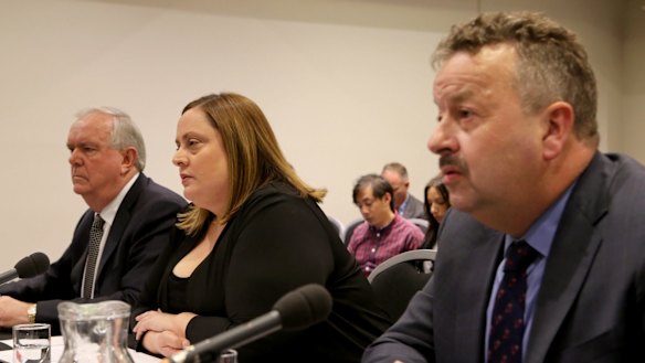 Warren Wilmot (right), the boss of OTR, at a senate inquiry when he was CEO of 7-Eleven. 