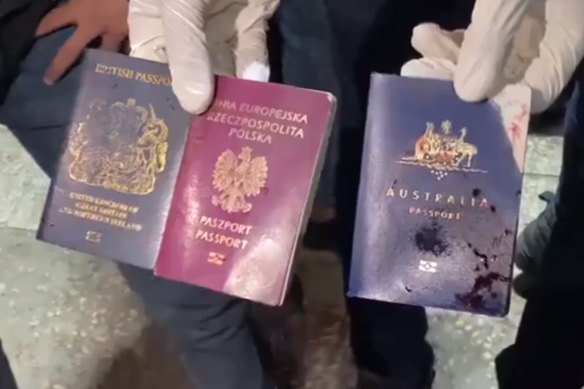 The bloodstained passports of three foreign nationals shown in a video shared on social media.