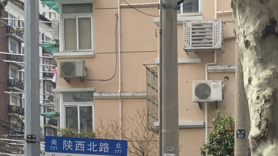 A police officer in protective gear watches over residents lining up for COVID tests in the Jingan district of western Shanghai, China, Friday, April 1, 2022. As residents of western Shanghai start a four day lockdown for mass testing, some in eastern Shanghai about to end their lock down are being told they will be confined to their homes for at least 10 more days. It was the latest wrinkle in the lockdown of China’s largest city as it struggles to eliminate an omicron-driven coronavirus outbreak under China’s zero-COVID policy. 