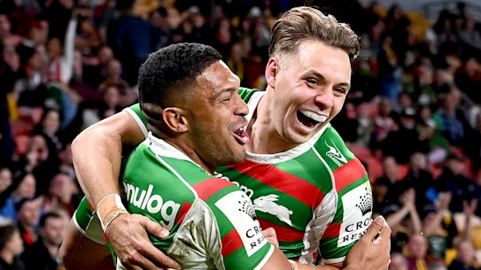Rabbitohs winger Taane Milne (left) celebrates a try with Blake Taaffe.