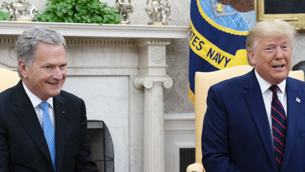 US President Donald Trump speaks while Sauli Niinisto, Finland's president, smiles during a meeting at the Oval Office.