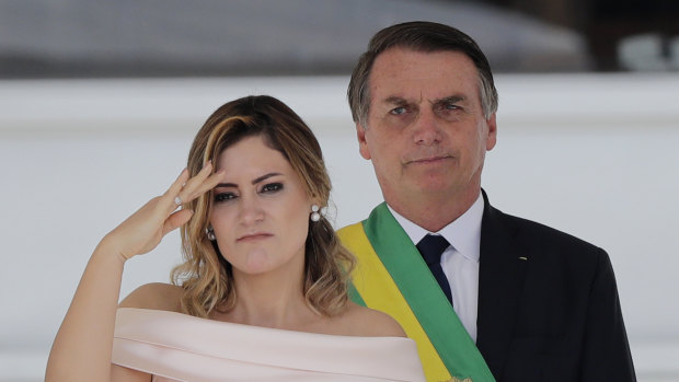 Brazil's new first lady Michelle Bolsonaro, pictured with husband Jair Bolsonaro, gives a military salute from the Planalto Presidential palace, in Brasilia, Brazil, on January 1.