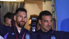 Lionel Messi, with coach Lionel Scaloni, holds the FIFA World Cup aloft as the team arrives back in Buenos Aires.