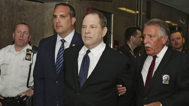 Harvey Weinstein is escorted in handcuffs to a New York court room.